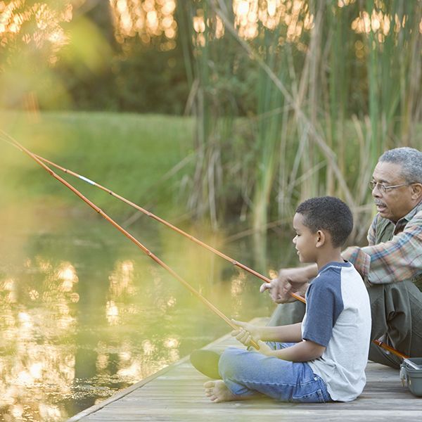grandfather and grandson fishing on pier fishing is a good housekeeping pick for best camping activity