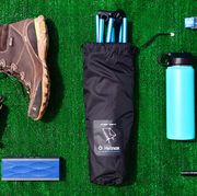 hiking boots, helinox camping chair, water bottle, headlamp, wool socks