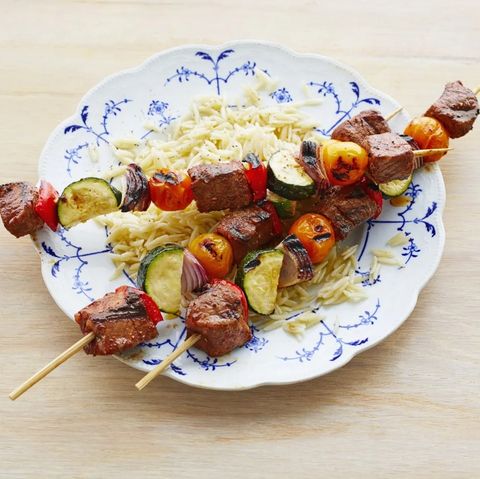 beef vegetable kebabs on plate with orzo