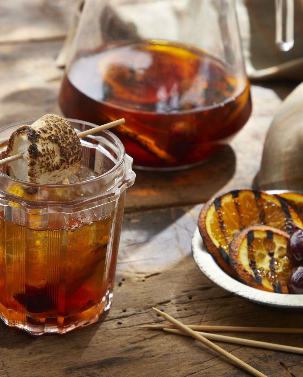 grilled orange old fashioned in a jar with a toasted marshmallow for garnish