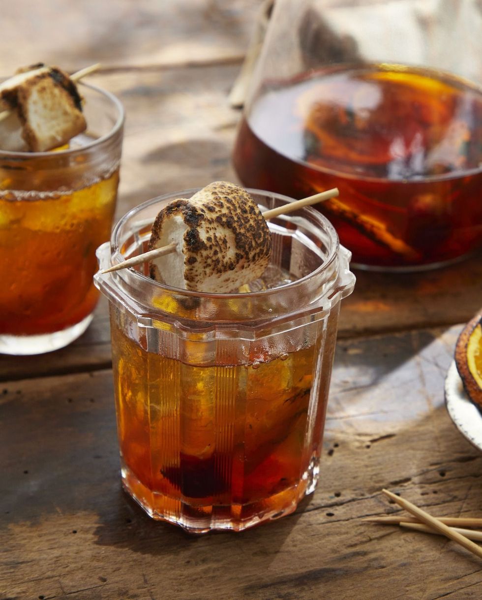grilled orange old fashioned in a jar with a toasted marshmallow for garnish