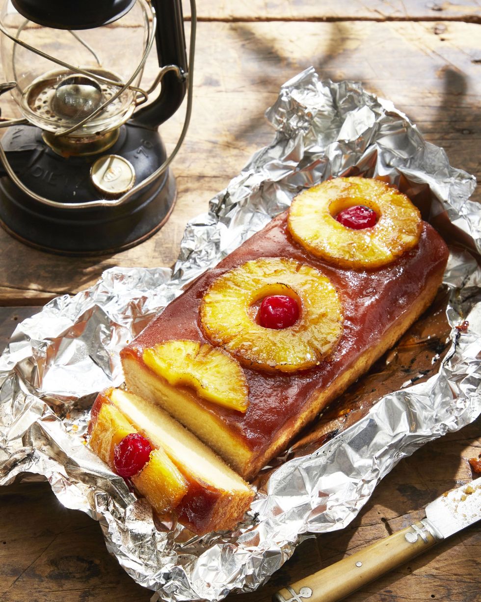 campfire grilled pineapple upside down cake on a sheet of unwrapped foil