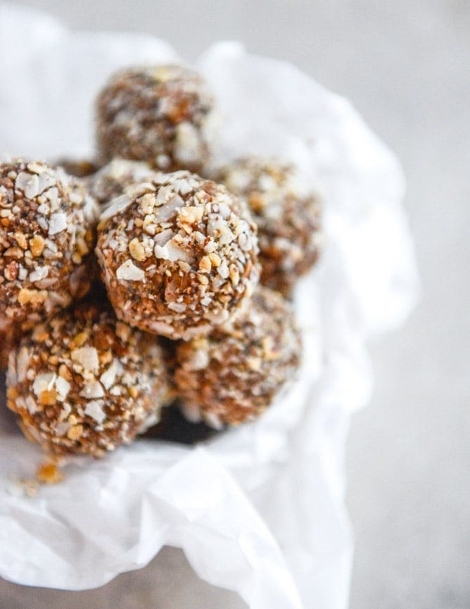 almond joy snack bites stacked in a parchment lined container