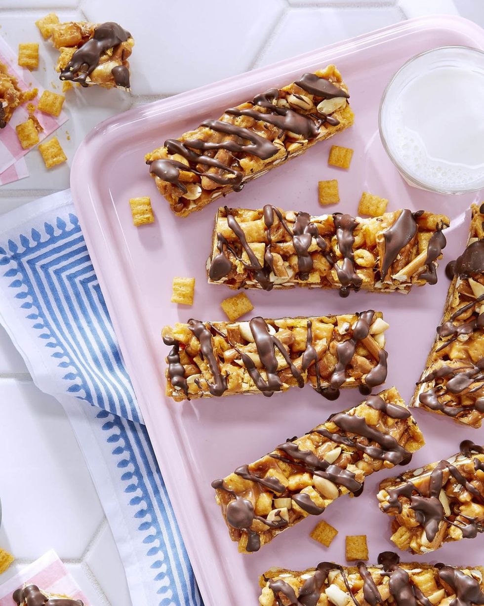 peanutty captain crunch candy bars arranged on a pink serving tray