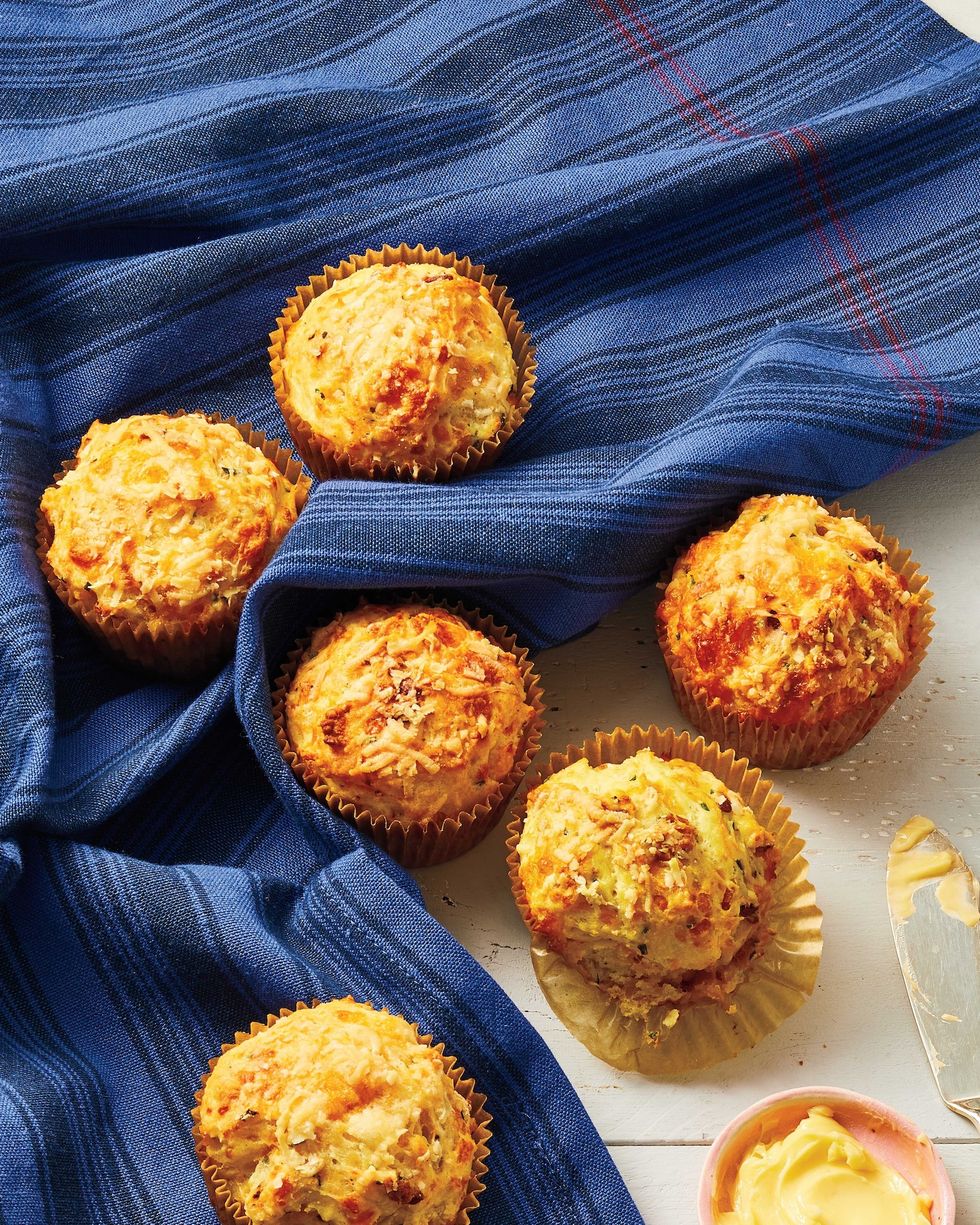cheddar bacon and chive breakfast muffins on a dark blue kitchen towel