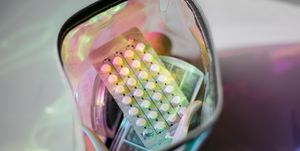 birth control pills in a metallic holographic bag