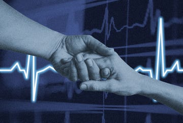 two hands clasping with a heart rate monitor display in the background