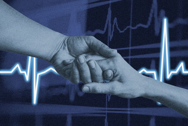 two hands clasping with a heart rate monitor display in the background