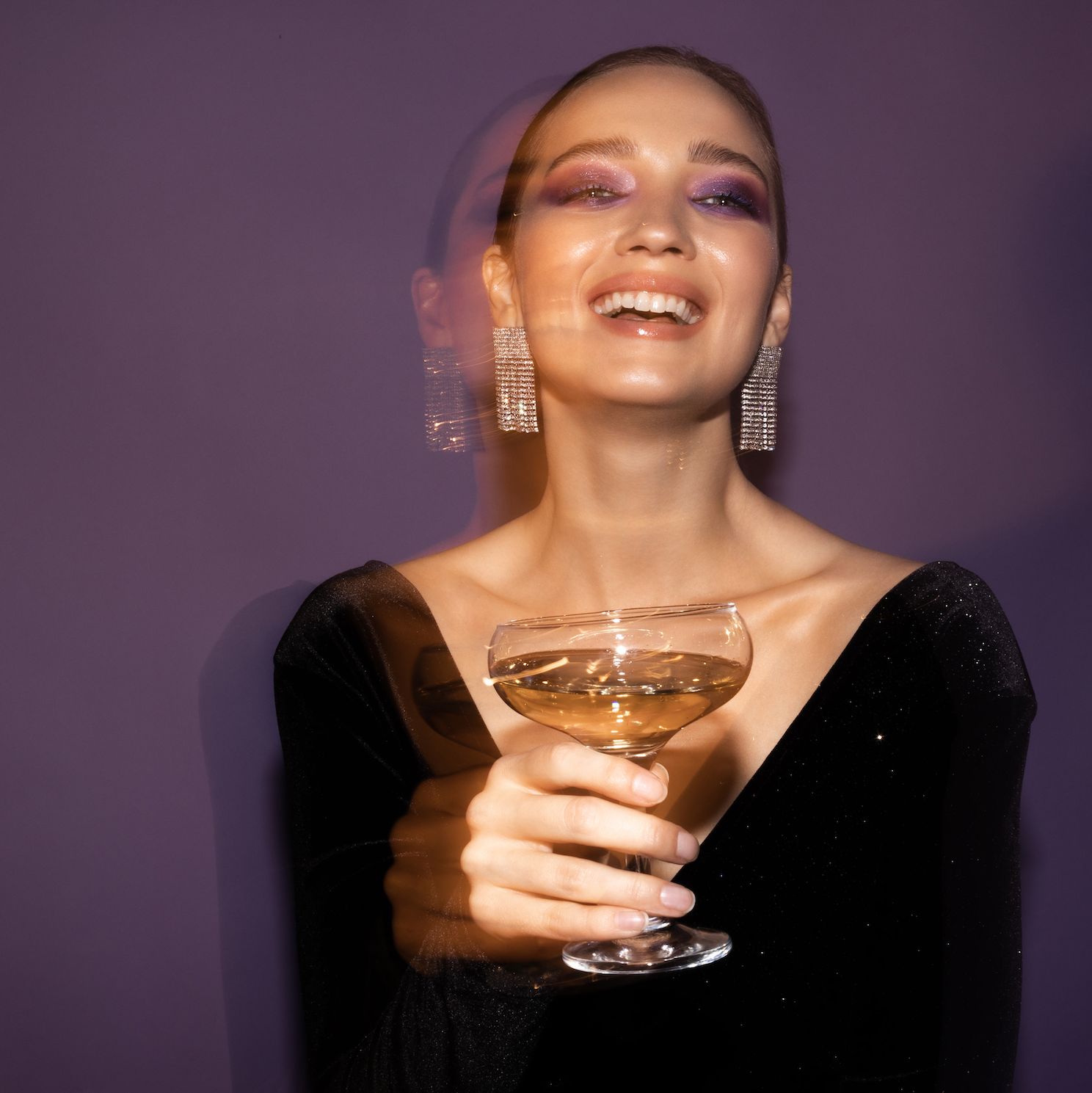 a woman holding a glass of wine
