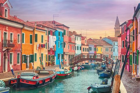 Canal and colorful houses of Burano, Italy at dusk