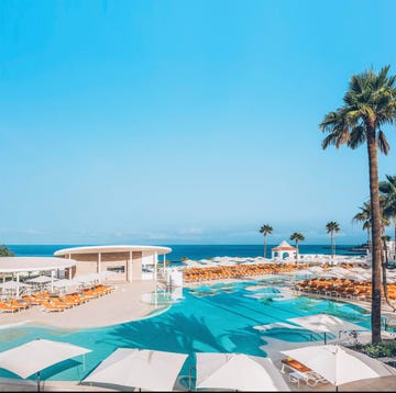 Ibstar hotel resort poolside scene with lounge chairs and palms