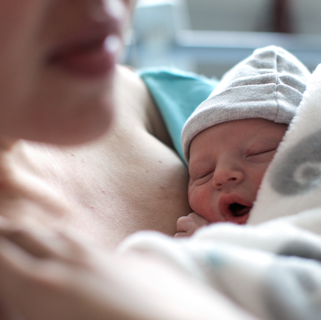 woman cradles newborn baby