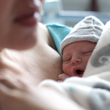 woman cradles newborn baby