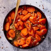 candied carrots with thyme and pecans in a black bowl