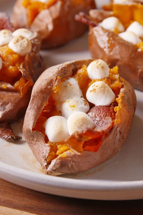 closeup of a baked sweet potato topped with candied bacon and mini marshmallows