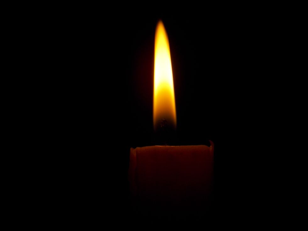 a candle glowing in the dark