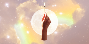 a hand holds up a lit match over a background of a full moon and a cloudy rainbow sky