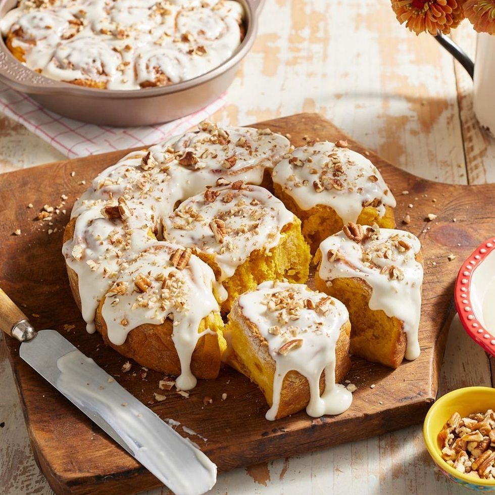 pumpkin spice cinnamon rolls with glaze and nuts