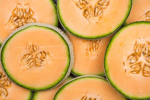Cantaloupe melon slices, full frame food background
