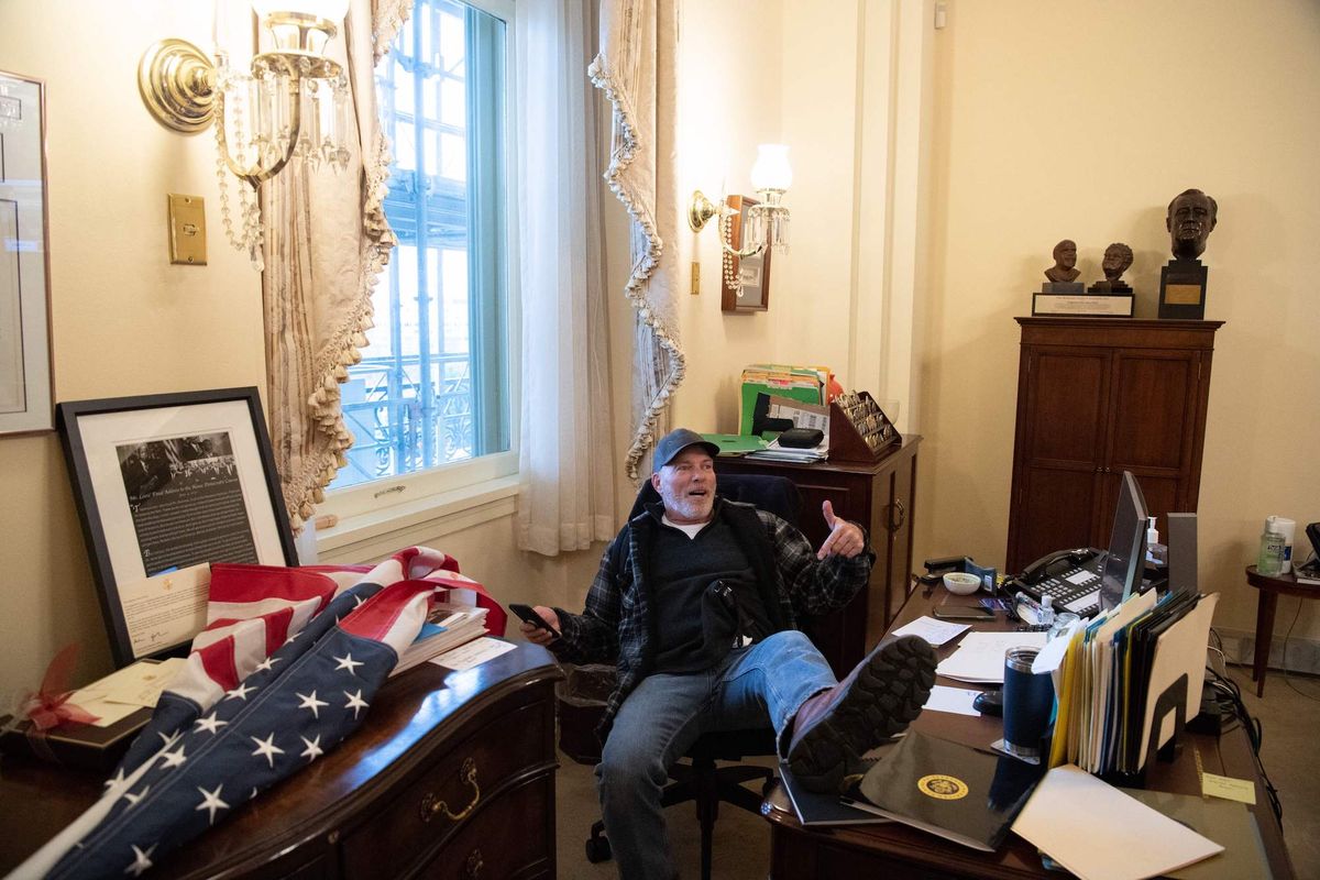 topshot   richard barnett, a supporter of us president donald trump sits inside the office of us speaker of the house nancy pelosi as he protest inside the us capitol in washington, dc, january 6, 2021   demonstrators breeched security and entered the capitol as congress debated the a 2020 presidential election electoral vote certification photo by saul loeb  afp photo by saul loebafp via getty images