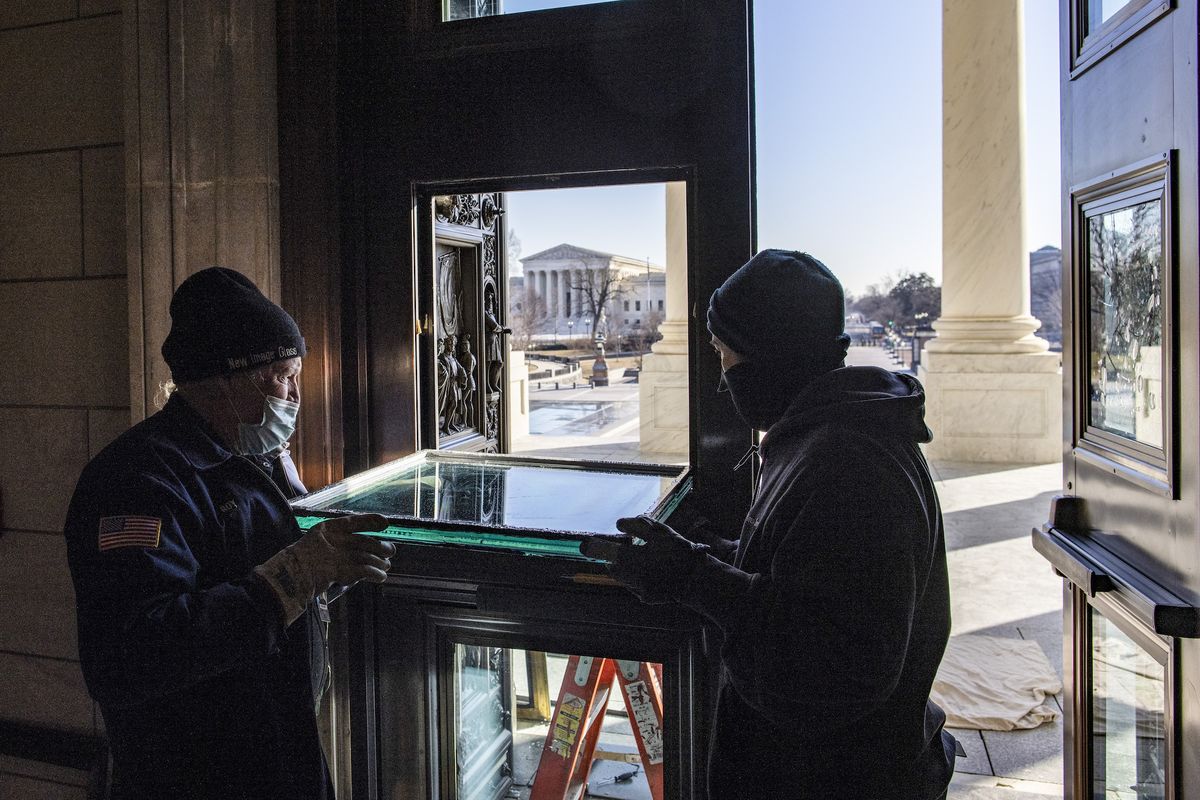 washington, dc   february 08 workers repair glass on the east front rotunda doors that was damaged during the january 6 attack on the us capitol on february 08, 2021 in washington, dc former us president donald trump faces trial on a single article of impeachment that accuses him of incitement of insurrection at the us capitol, which left five people dead, including a capitol police officer photo by tasos katopodisgetty images