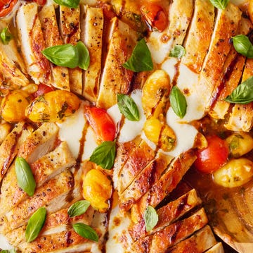 Caprese Chicken Gnocchi Skillet chicken with gnocchi, tomatoes, and cheese in a red skillet