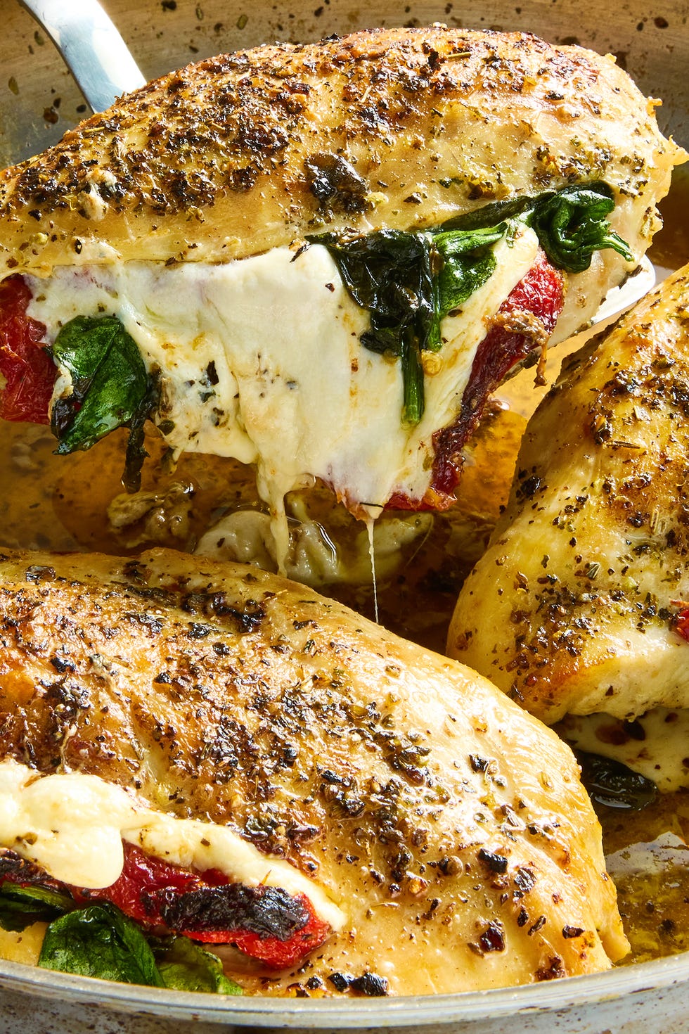 chicken breasts sliced and stuffed with mozzarella cheese, sun dried tomatoes and spinach