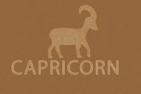 capricorn  horoscope sign in paper craft brown background