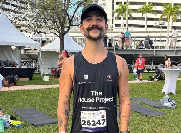 participant in a charity event wearing a tank top with a visible bib number