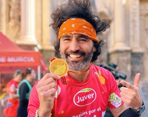 runner celebrating with a medal after a race