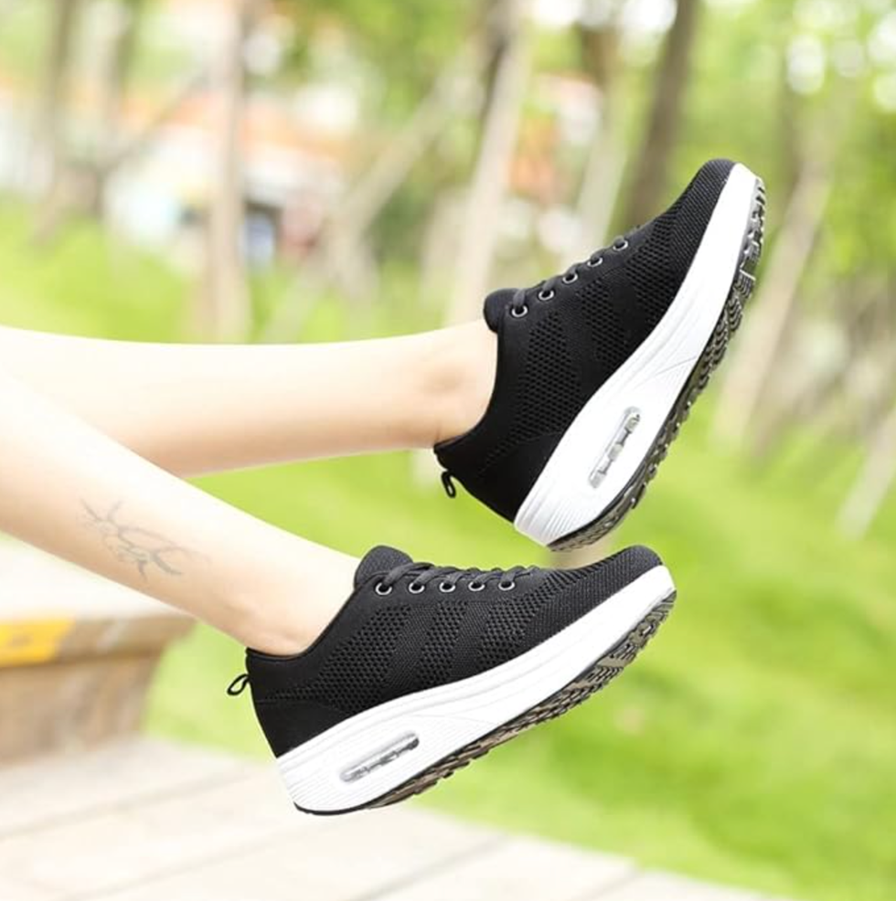 black sneakers with a white sole shown in action