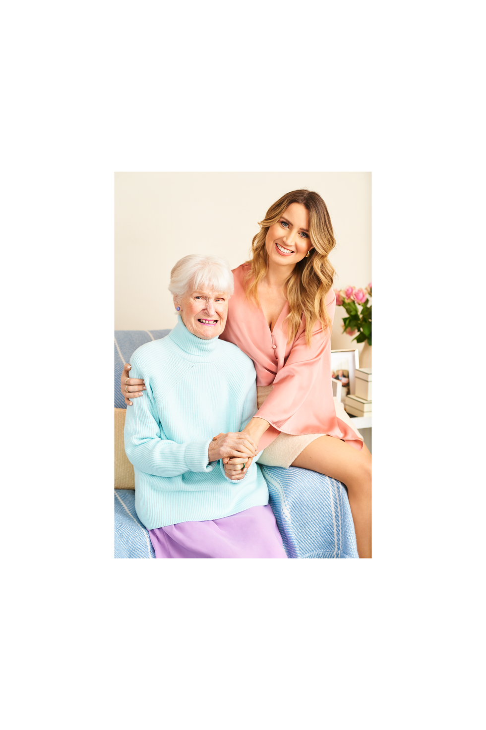 two women sitting on a couch showcasing a bond between them