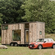 This is an image tiny homes with mini coopers in front of them