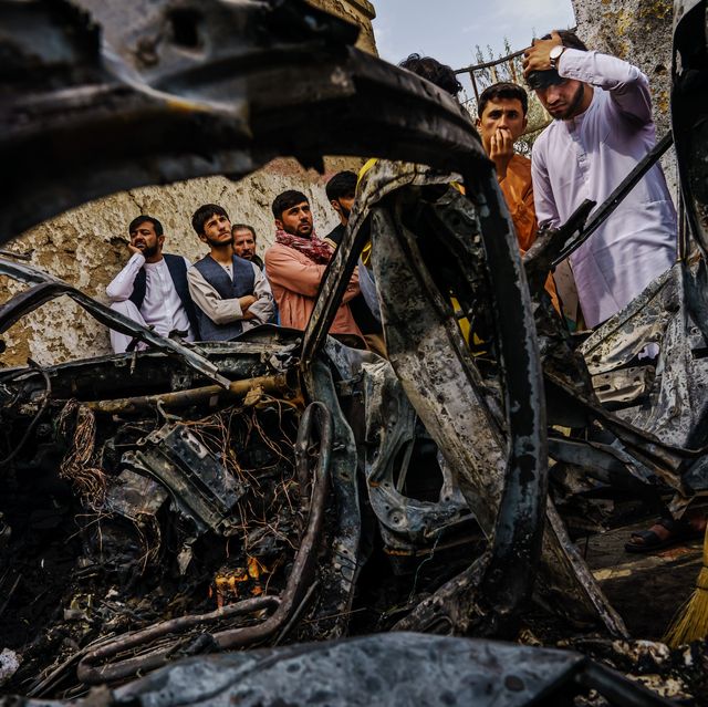 kabul, afghanistan    august 30, 2021 relatives and neighbors of the ahmadi family gathered around the incinerated husk of a vehicle targeted and hit earlier sunday afternoon by an american drone strike, which killed 10 people including children, in kabul, afghanistan, monday, aug 30, 2021 marcus yam  los angeles times