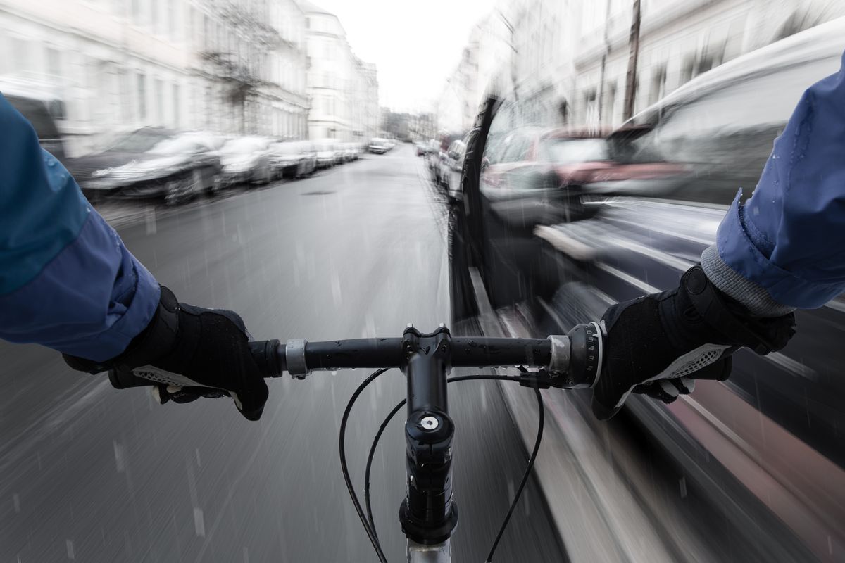 Car-dooring -- Cyclist in the rain on collision course with car door