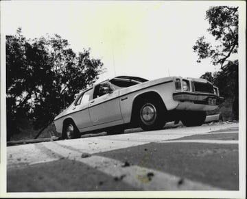 a car drives over speed control hump in carinya rd, picnic point