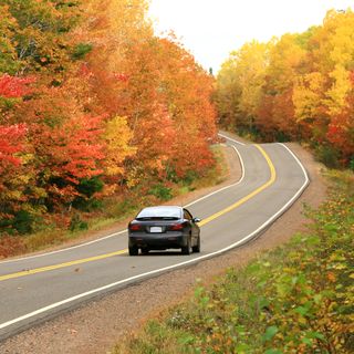 car driving on remote appalachian highway in fall