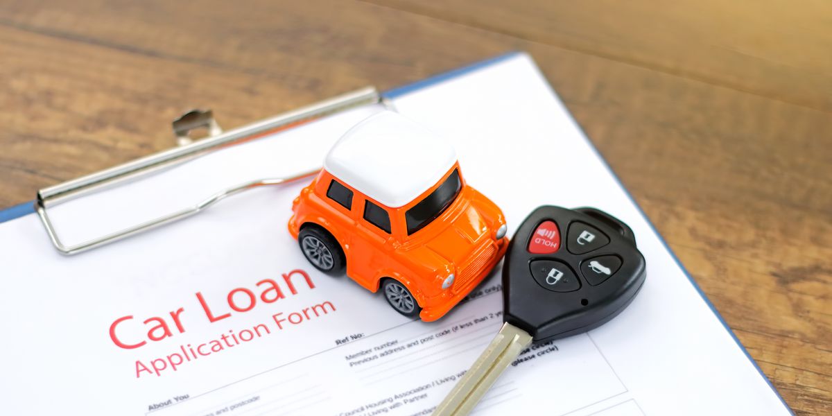 Car loan application form as example, with a tiny toy car and car keys over it.