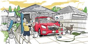 a family takes delight in washing their red family vehicle