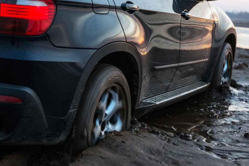 car stuck in a muddy road