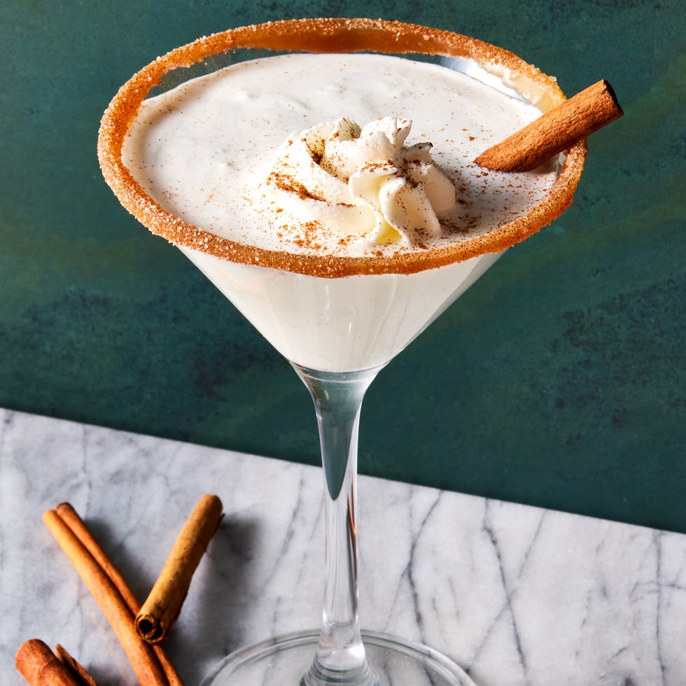 caramel snickerdoodle martini with a caramel rim, whipped cream and cinnamon