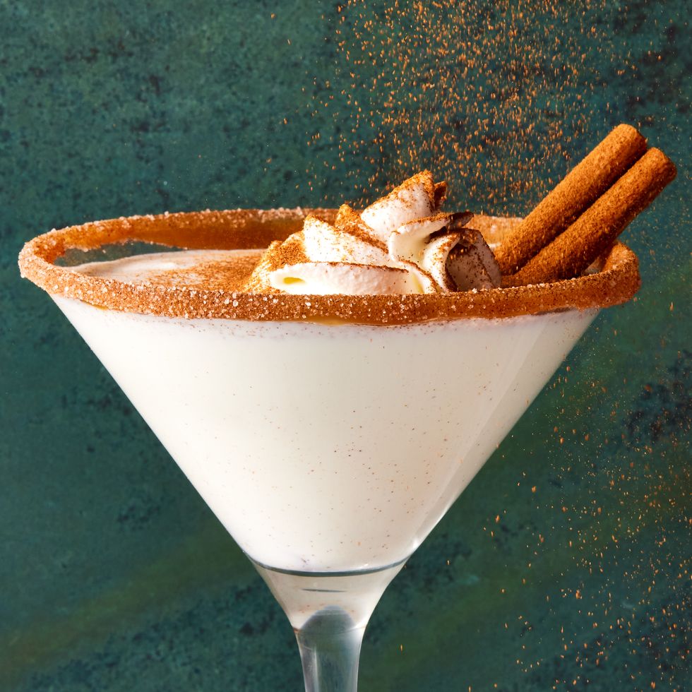 caramel snickerdoodle martini with a caramel rim, whipped cream and cinnamon