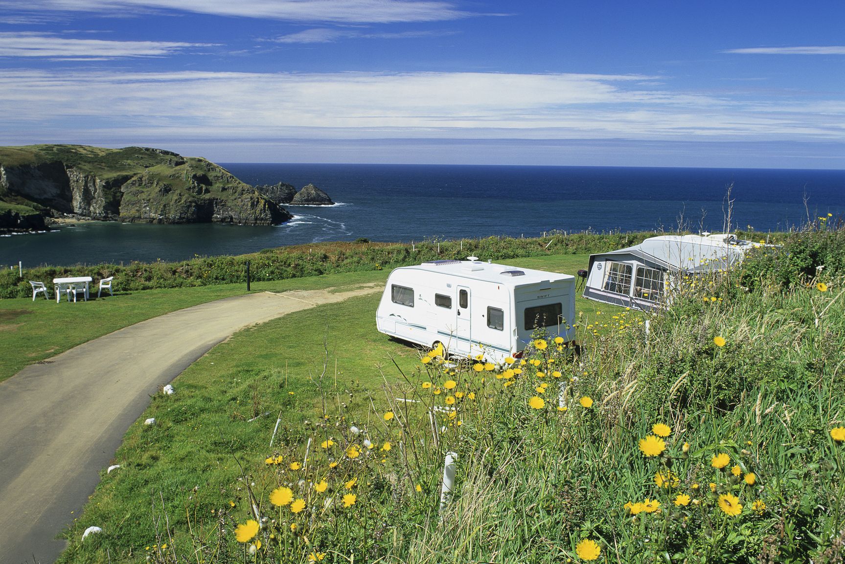 Trewethett Farm Caravan Club Site, Cornwall, England. Caravans with breathtaking views to the sea as the site boasts a cliff top setting, overlooking Bossiney Cove with its safe and sandy beach.
