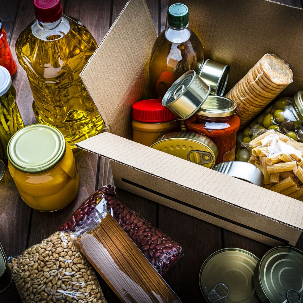 cardboard box filled with nonperishable foods on wooden table