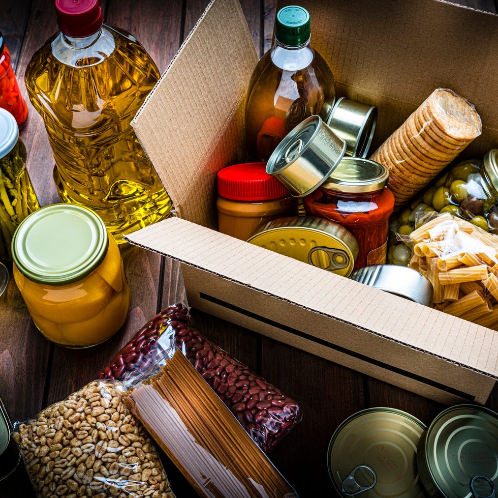 cardboard box filled with nonperishable foods on wooden table