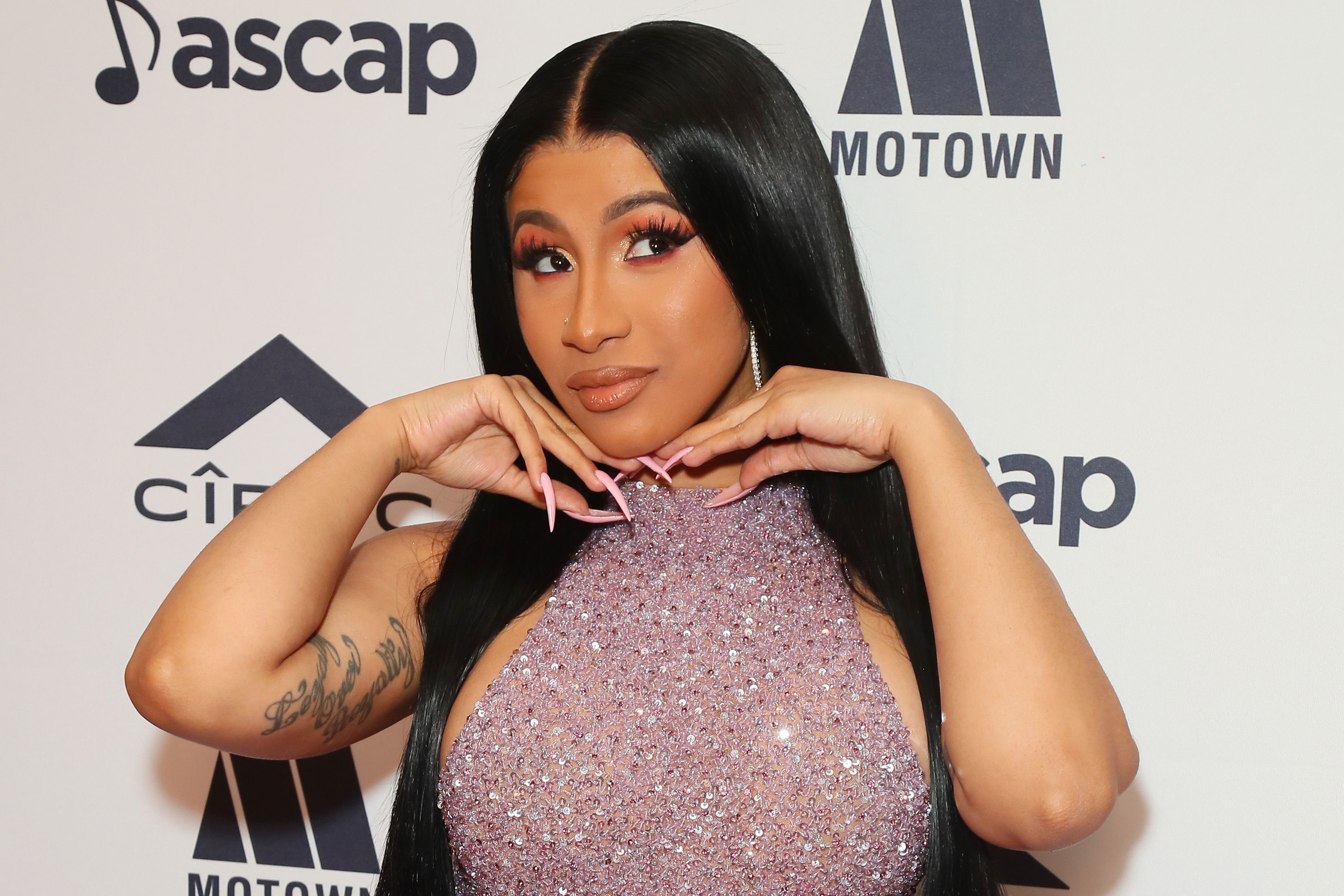 Cardi B just wore a metallic thong with sock boots