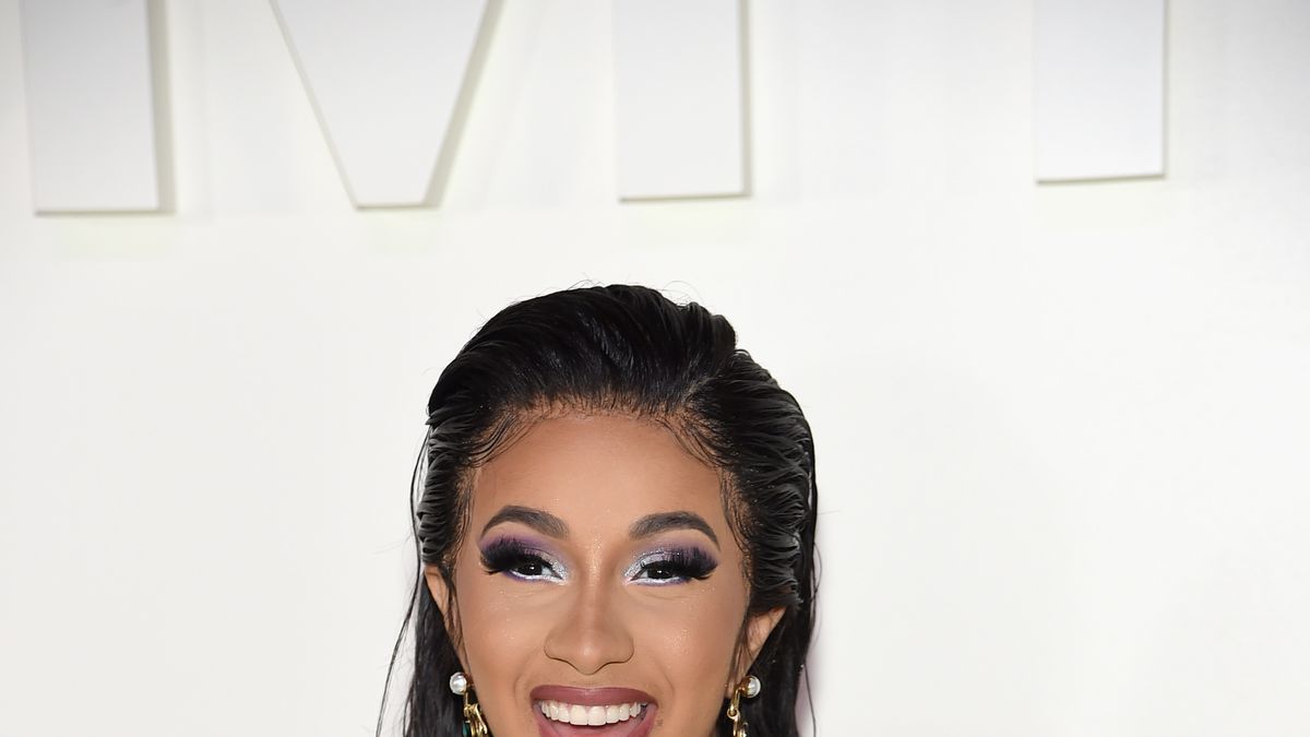 Cardi B shows off her chest piercings in new photos