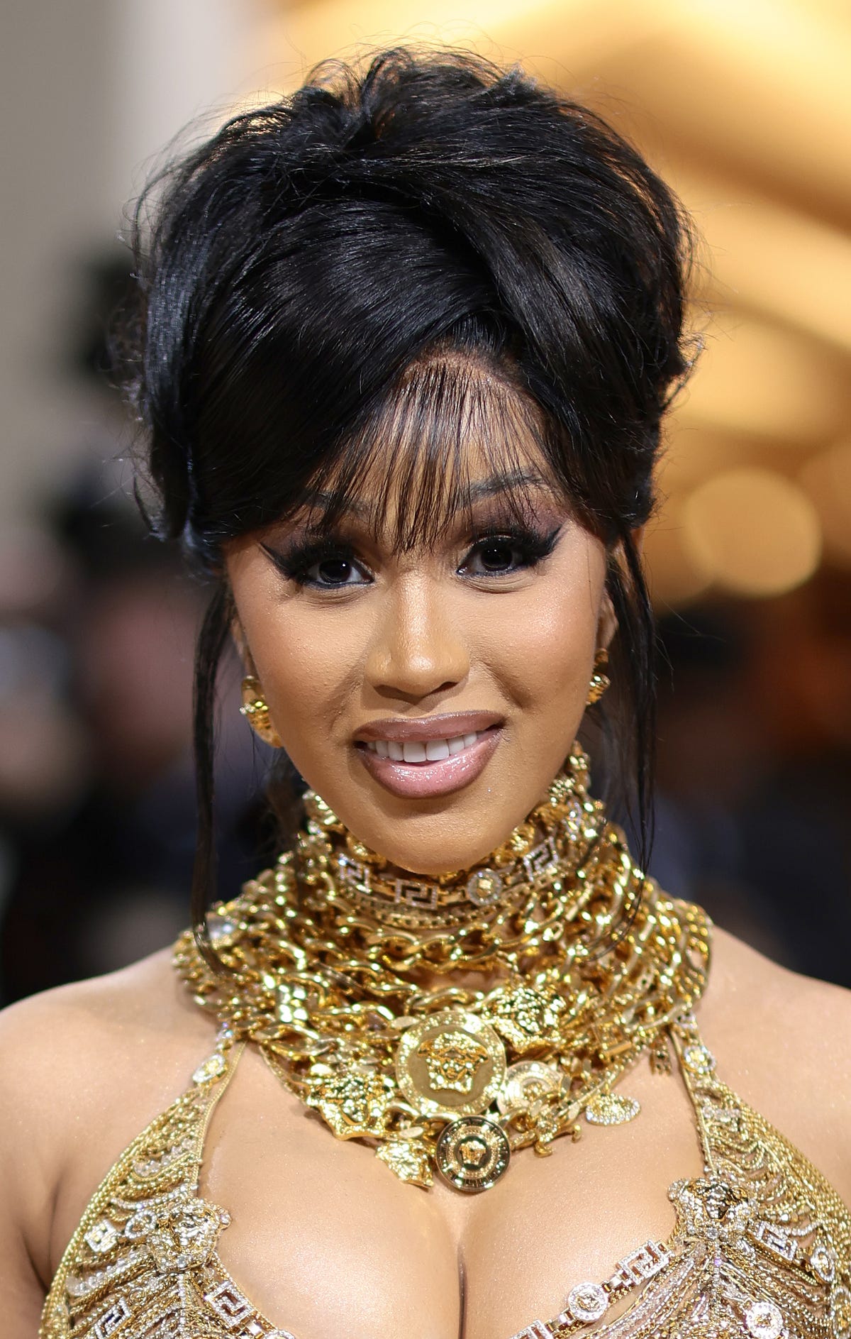 Cardi B's Burgundy Updo Reminds Us of Pamela Anderson's '90s Messy Bun