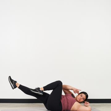 kristine zabala performs a bicycle crunch as part of a cardio core workout