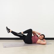 kristine zabala performs a bicycle crunch as part of a cardio core workout